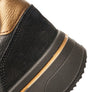 Close-up of a black and gold shoe