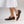 Pair of brown leather shoes worn by someone in a dress