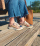 Person wearing sandals on a wooden deck